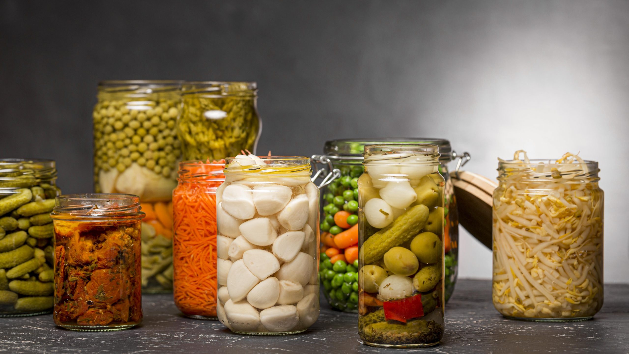 front-view-of-assortment-of-vegetables-pickled-in-clear-glass-jars